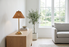 Cordless rattan-effect table lamp on a white oak sideboard in a bright Scandinavian living room