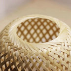 Close-up of the hand-woven bamboo weave of the Bambou table lamp