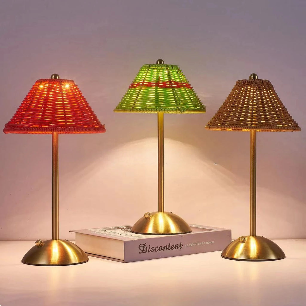 Cordless rechargeable table lamps in green, red and brown, glowing in the evening