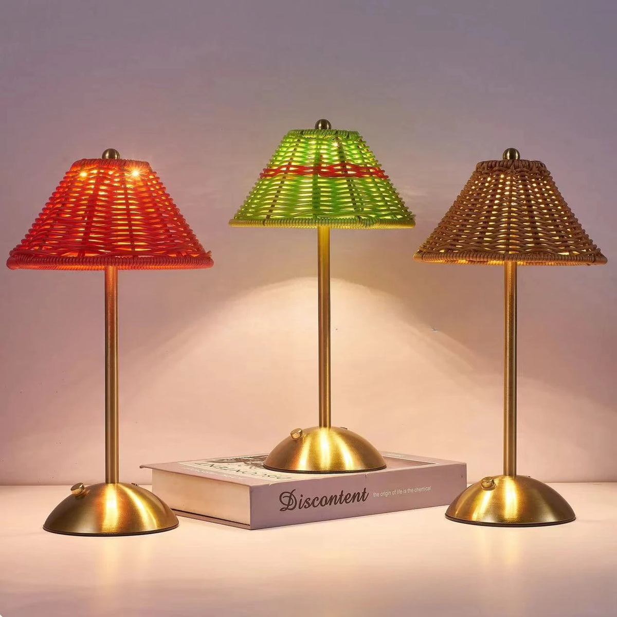Cordless rechargeable table lamps in green, red and brown, glowing in the evening