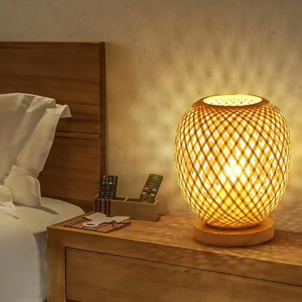 Bambou bamboo table lamp glowing at night on a bedside table